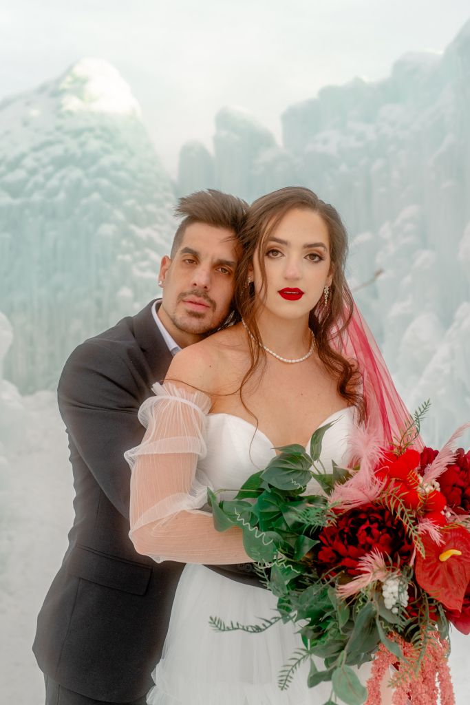 A look at the maximalist, free form bouquet at the Ice Castles in Midway, held by Kalli and paired with male model Andrea.
