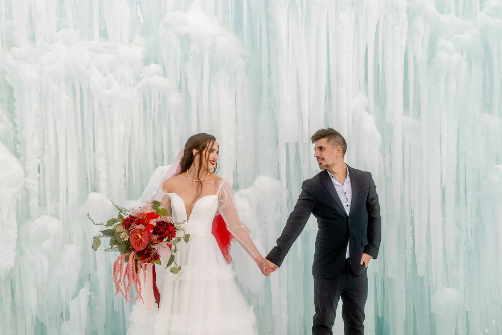 A look at the maximalist, free form bouquet at the Ice Castles in Midway, held by Kalli and paired with male model Andrea.
