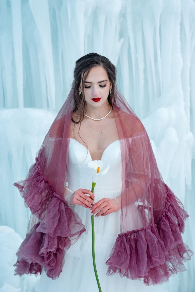 Kalli switches into a plum drop veil with a single lily as a bouquet to show alternative ways to show off colored veils.